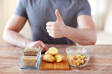 Image showing close up of male hands with carbohydrate food