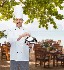 Image showing happy male chef cook holding cloche