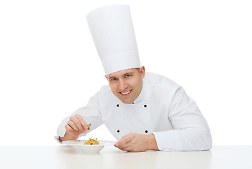 Image showing happy male chef cook decorating dish