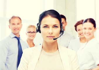 Image showing helpline operator with headphones in call centre