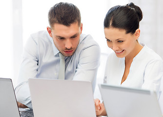 Image showing group of people working with laptops in office