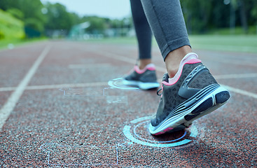 Image showing close up of woman feet running on track from back