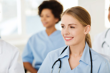 Image showing happy doctor over group of medics at hospital