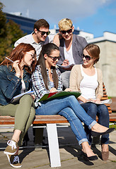 Image showing group of happy students with notebooks at campus