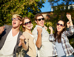 Image showing group of happy friends showing triumph gesture