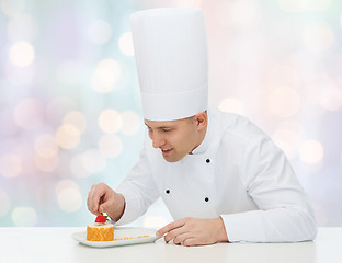 Image showing happy male chef cook decorating dessert