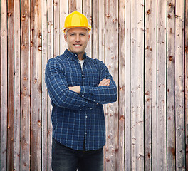 Image showing smiling male builder or manual worker in helmet