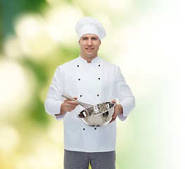 Image showing happy male chef cook whipping something with whisk