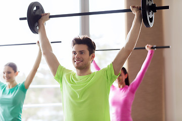 Image showing group of people exercising with barbell in gym