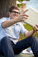 Image showing happy teenage boy with tablet pc taking selfie