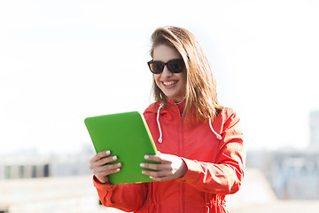 Image showing happy young woman or teenage girl with tablet pc