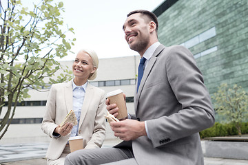 Image showing smiling businessmen with paper cups outdoors