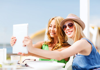 Image showing girls taking photo in cafe on the beach