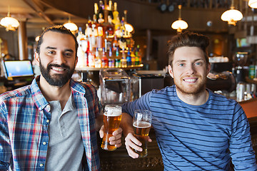 Image showing happy male friends drinking beer at bar or pub