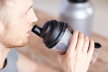 Image showing close up of man drinking protein shake