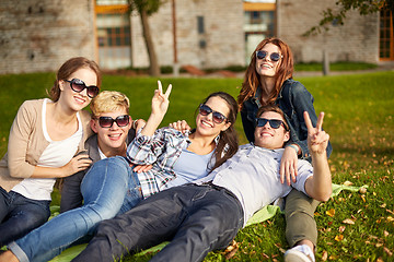 Image showing group of happy students showing victory gesture