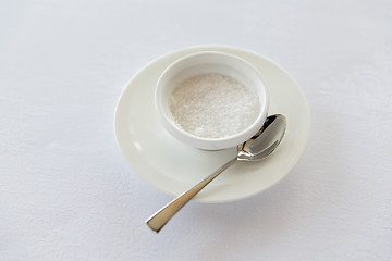 Image showing sugar bowl and saucer with spoon on table