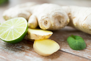 Image showing close up of ginger root and lime on wooden table