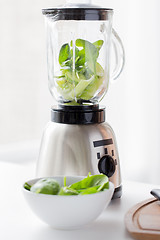 Image showing close up of blender jar and green vegetables