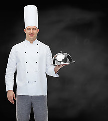 Image showing happy male chef cook holding cloche