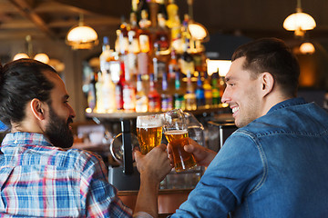 Image showing happy male friends drinking beer at bar or pub