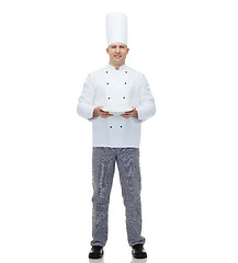 Image showing happy male chef cook showing empty plate