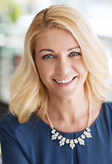 Image showing happy smiling blonde woman in blue clothes