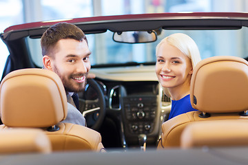 Image showing happy couple sitting in car at auto show or salon