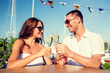 Image showing smiling couple drinking champagne at cafe