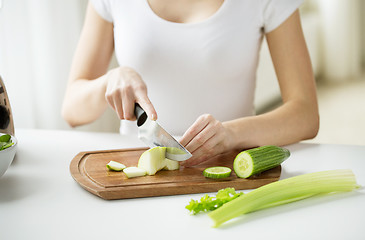 Image showing close up of woman chopping green vegetables