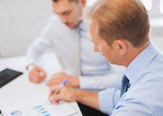 Image showing businessmen with notebook on meeting