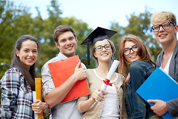 Image showing group of smiling students with diploma and folders