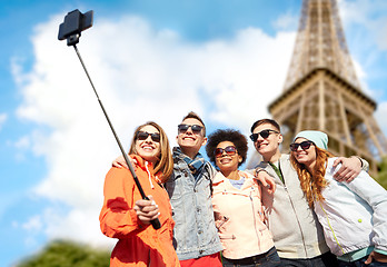 Image showing smiling friends taking selfie with smartphone