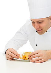 Image showing close up of male chef cook decorating dessert