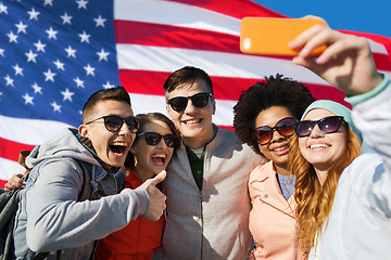 Image showing smiling friends taking selfie with smartphone