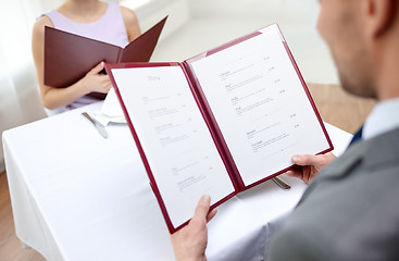 Image showing close up of couple with menu at restaurant