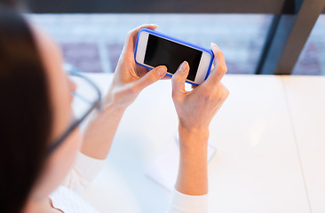 Image showing close up of woman with smartphone at office