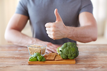 Image showing close up of male hands showing food rich in fiber