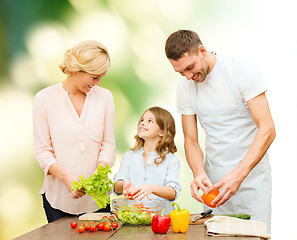 Image showing happy family cooking vegetable salad for dinner