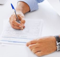 Image showing man filling tax form