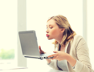 Image showing woman sending kisses with laptop computer