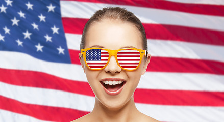 Image showing happy teenage girl in shades with american flag