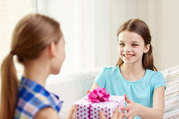 Image showing happy little girls with birthday present at home