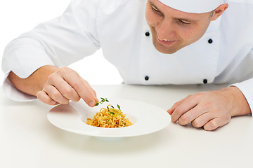 Image showing happy male chef cook decorating dish