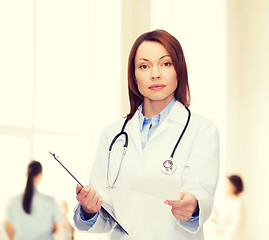 Image showing calm female doctor with clipboard