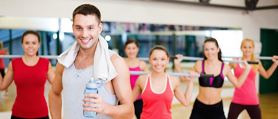 Image showing smiling trainer in front of group of people