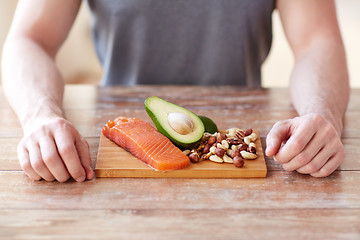 Image showing close up of male hands with food rich in protein