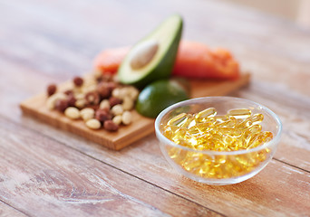 Image showing close up of omega 3 capsules and food on table
