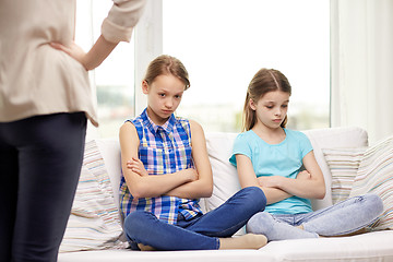 Image showing upset guilty little girls sitting on sofa at home