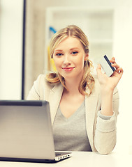 Image showing happy woman with laptop computer and credit card